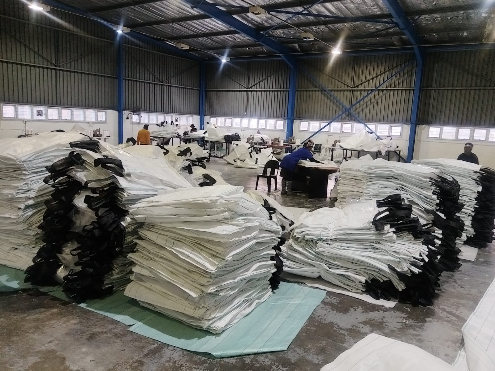 Industrial manufacturing floor with machinery and woven packaging production